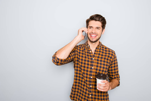 Portrait of happy man talking on phone and drinking tea - Photo, Image