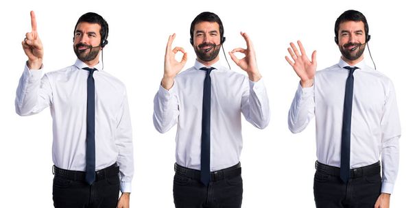 Young man with a headset making OK sign - Photo, Image