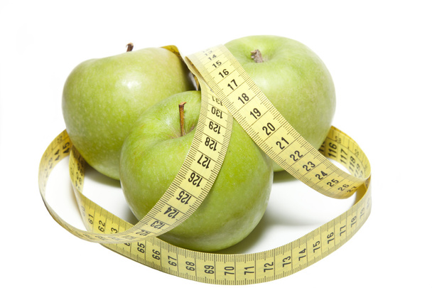 Apple with a tape measure - Foto, afbeelding
