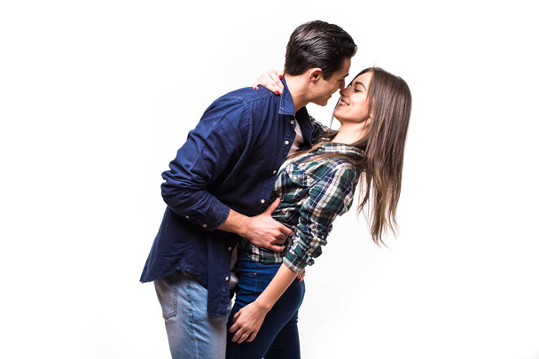 Young in love couple kissing on white background - Фото, изображение