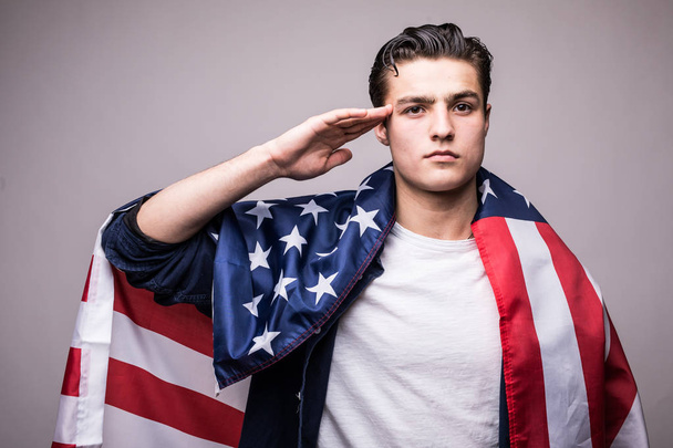 Man in american flag salutes - Foto, Bild