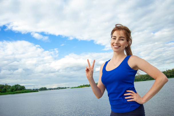 smiling casual girl raised victory sign - Photo, Image