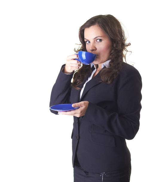 Attractive young smiling girl in a black business suit drinking - Φωτογραφία, εικόνα