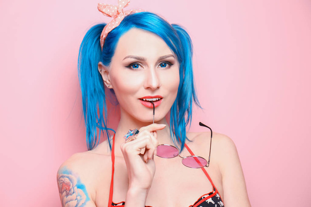 Beautiful young woman with stylish color hair and tattoo on pink background - Φωτογραφία, εικόνα