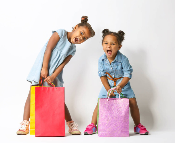 Two cute African girls with shopping bags - Fotografie, Obrázek