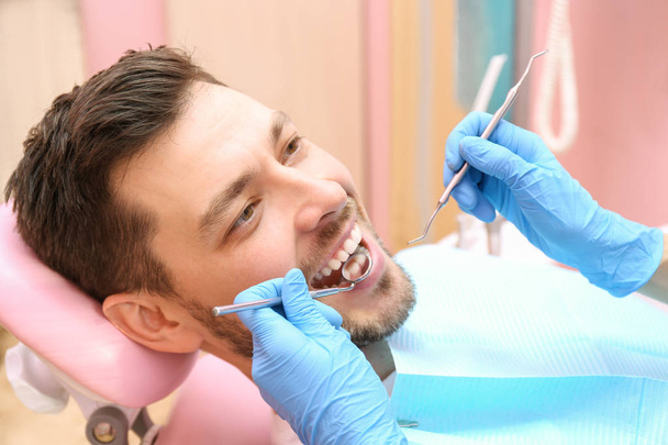 Dentist examining teeth of patient - Foto, Imagen