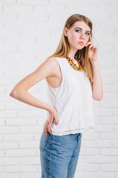 Pretty young sexy fashion sensual woman posing on white wall background dressed in hipster style jeans outfit,Stylish fashionable blonde girl  in black clothes. ,not isolated - Φωτογραφία, εικόνα