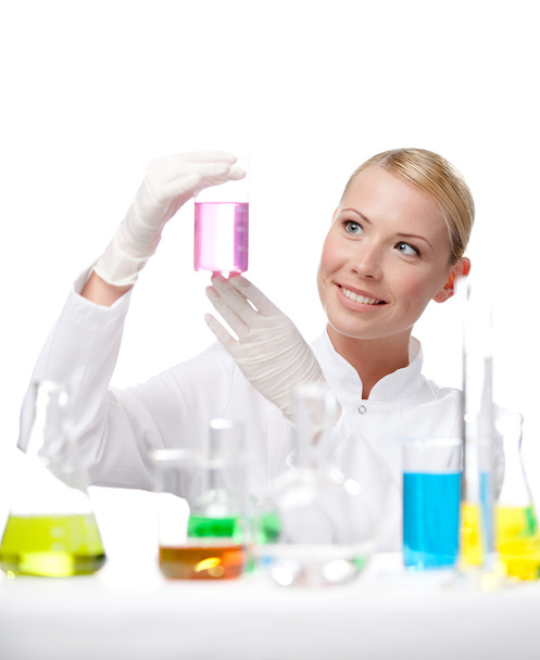 Young lady scientist looks at the beaker - Fotoğraf, Görsel