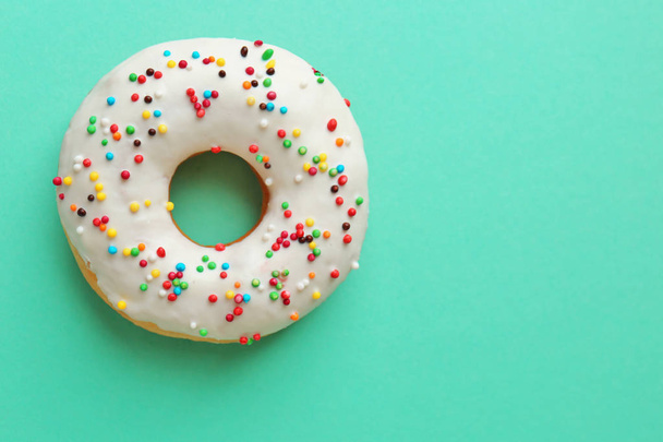 Delicious donut on mint green - Foto, afbeelding