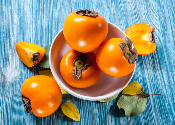 Persimmons on a table - Foto, imagen