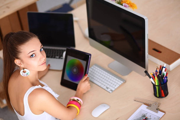 Young woman working in office, sitting at desk - Photo, Image