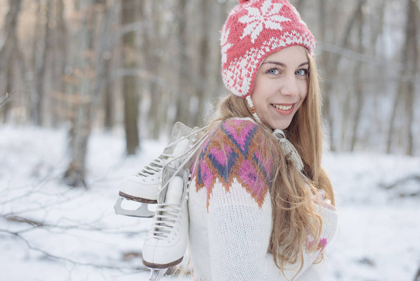 happy young woman posing outdoor with vintage ice skate - Фото, изображение