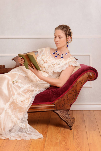 young victorian woman reading book - Фото, изображение