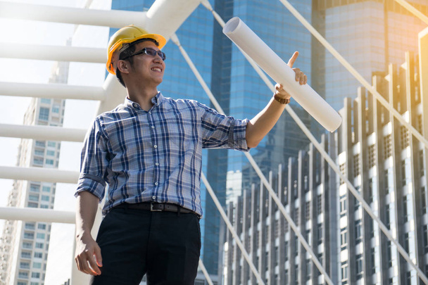 Foreman construction worker holding blueprint - Fotó, kép