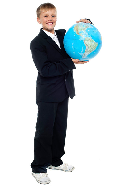 Smart looking young kid holding globe - Foto, imagen