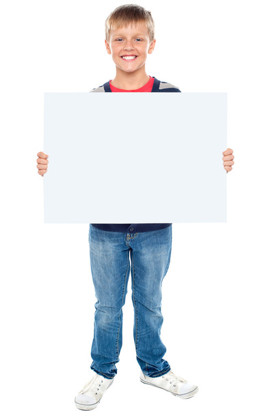 Full length portrait of boy holding blank whiteboard - 写真・画像