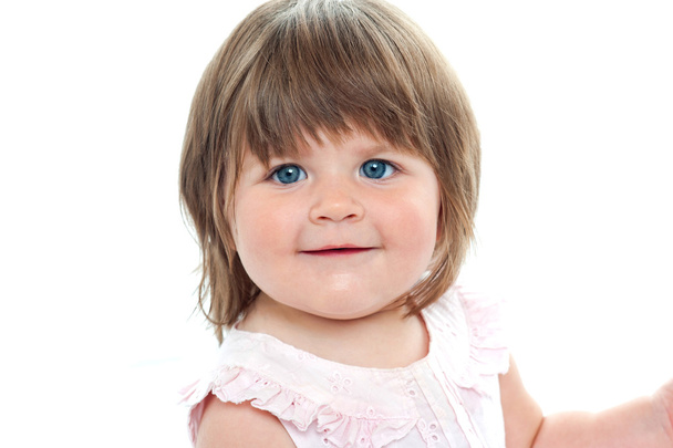 Closeup shot of a chubby female kid with blue eyes - Фото, изображение