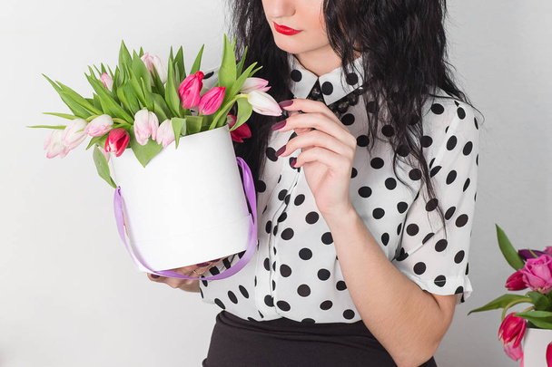 woman holding bouquet of roses and tulips in box - Photo, Image