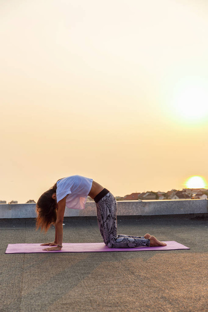 Young woman practicing yoga - Фото, зображення