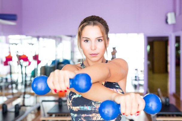 woman doing exercises with dumbbells - Photo, Image