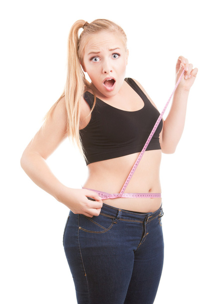Size 40 girl is shocked by measuring her waist - Zdjęcie, obraz