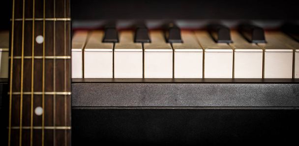 музичні інструменти клавіші для фортепіано та акустична гітара
 - Фото, зображення