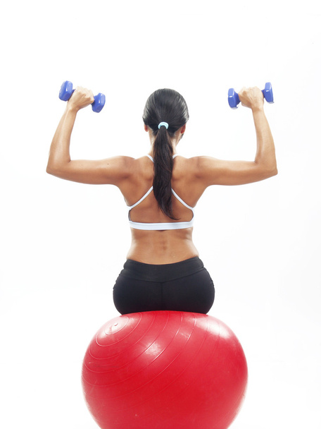 Young Woman doing fitness exercise with a red ball. - Φωτογραφία, εικόνα