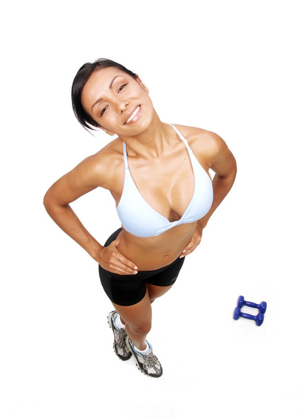 Young woman doing fitness exercise behind a hand weights. - Foto, imagen
