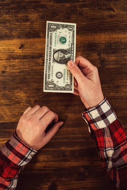 Female hands and one dollar tip - 写真・画像