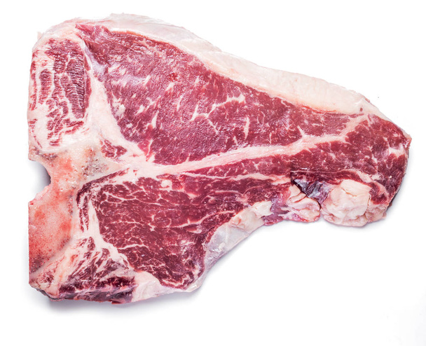 Raw T-bone steak on the white background. - Фото, зображення