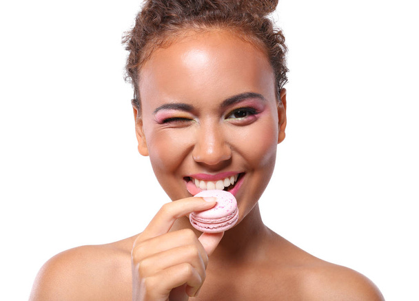 woman eating delicious macaroon - Photo, image