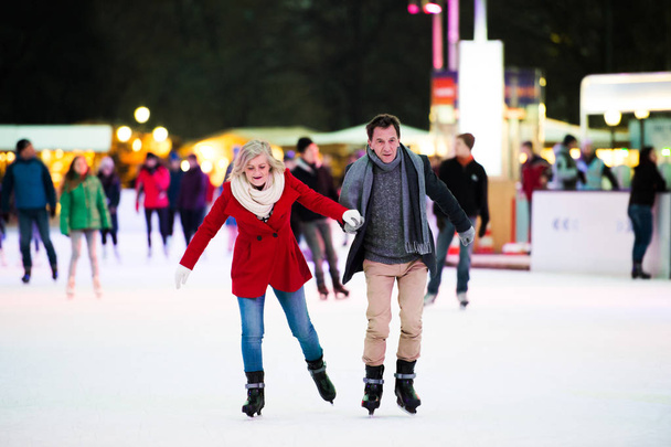 Beautiful senior couple ice skating in city centre. Winter - Fotoğraf, Görsel