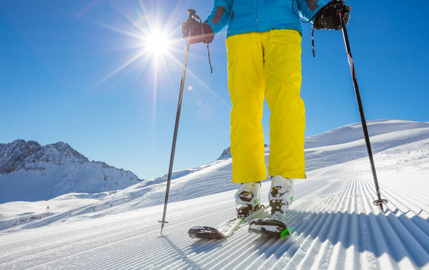 Man's legs in ski boots, standing on alpine skis - Foto, Bild