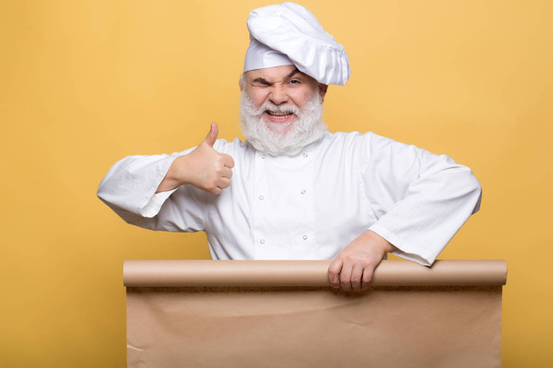 Chef man with empty paper - Zdjęcie, obraz