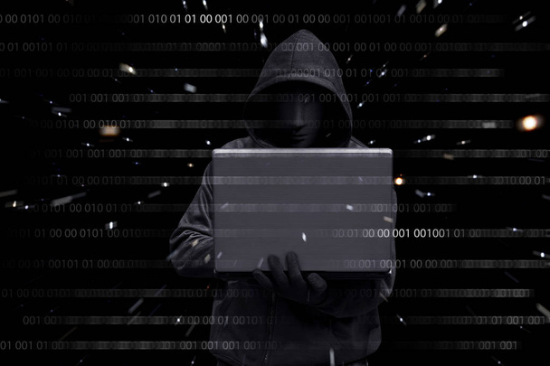 hacker holding laptop - Foto, afbeelding