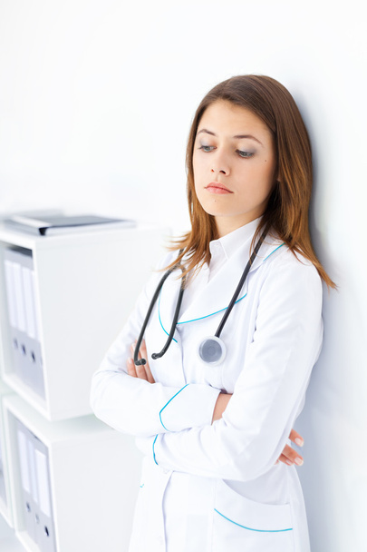 Portrait of pensive young female doctor in hospital - Φωτογραφία, εικόνα