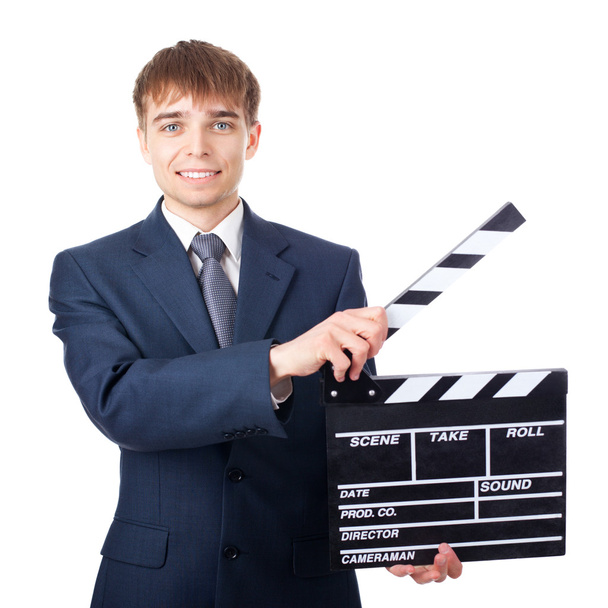 young smiling businessman with clapperboard isolated on white ba - Foto, imagen