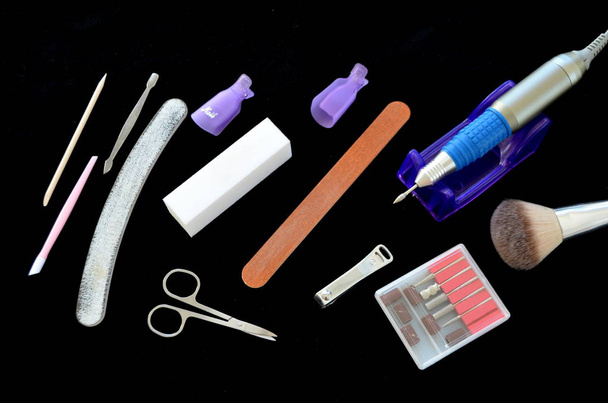 Tools for manicure on a black background - Foto, afbeelding