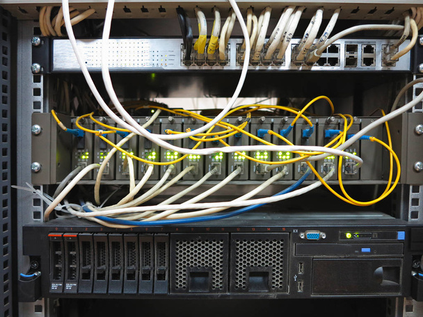 Server rack with internet patch cord cables connected to panel - Photo, Image