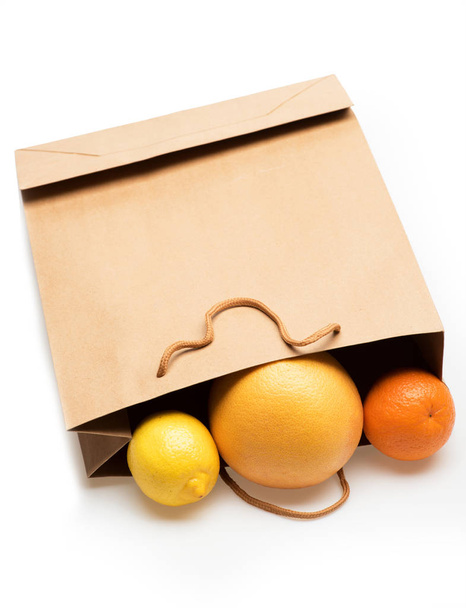 lemon, grapefruit and orange fruit in paper package - Fotoğraf, Görsel