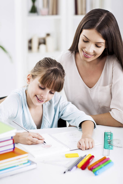 Mother and Daughter Doing Homework Together - 写真・画像