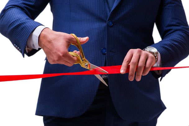 Businessman cutting red ribbon isolated on white - Photo, Image