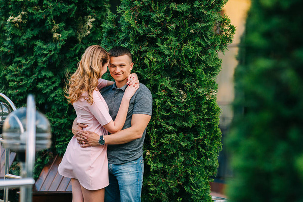 Pretty couple hugging and flirting in an urban park - Foto, immagini