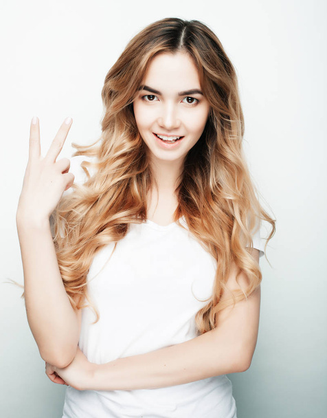 lovely woman showing victory or peace sign - Foto, imagen