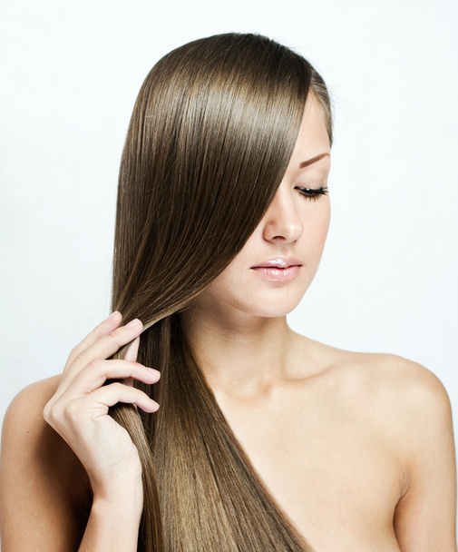 Closeup portrait of a beautiful young woman with long hair - Fotografie, Obrázek