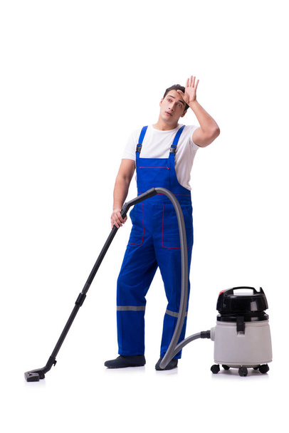 Man in coveralls doing vacuum cleaning on white - Photo, Image
