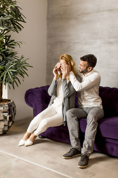 Couple sitting in sofa at home - Photo, Image