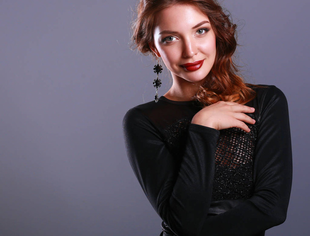Beautiful woman with evening make-up in black dress - Fotoğraf, Görsel