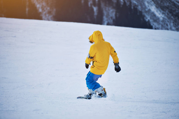 Snowboarding in mountains ski resort - Фото, изображение