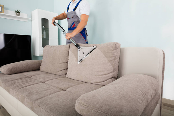 Worker Cleaning Sofa - 写真・画像